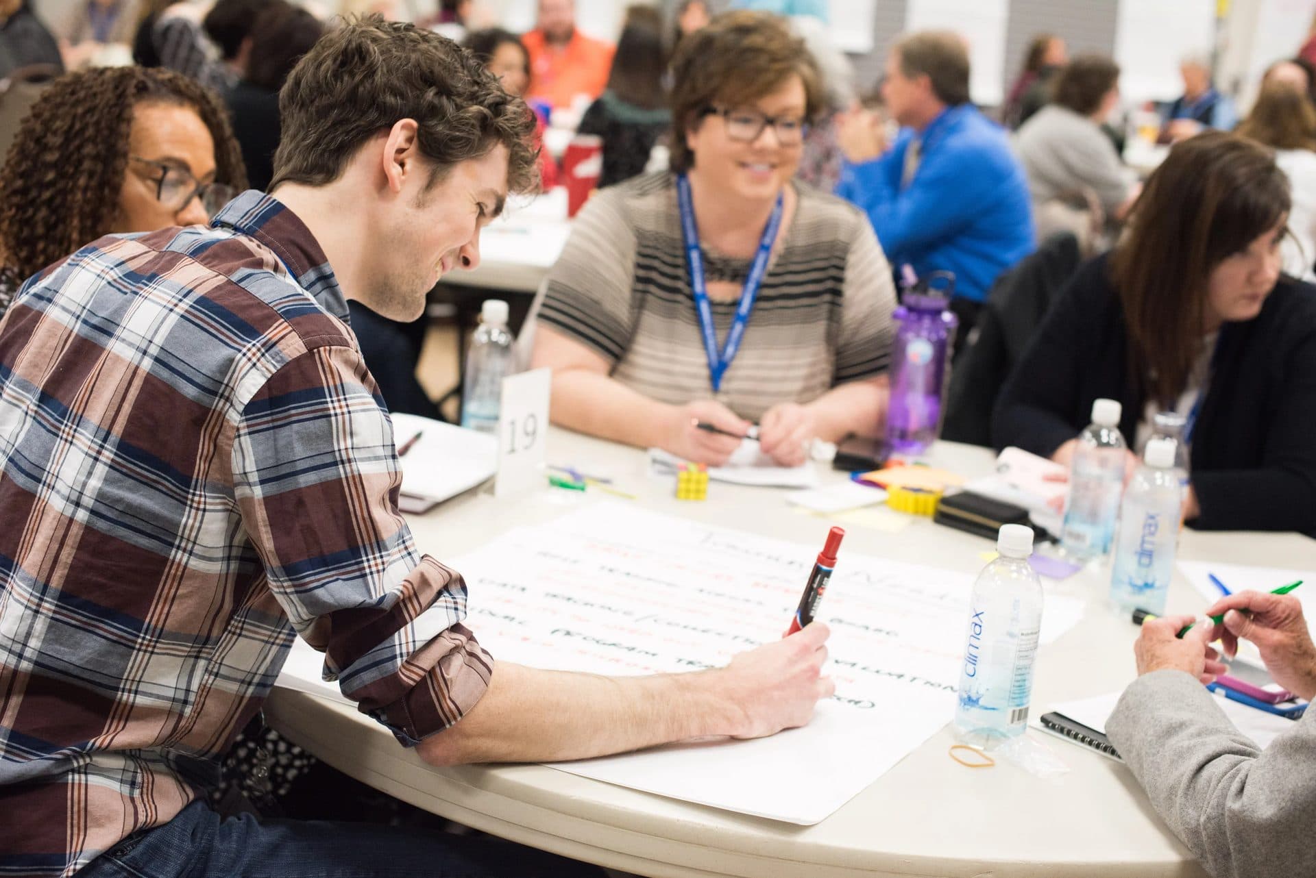 Attendees working together on a planning sheet at a Rural Summit table session