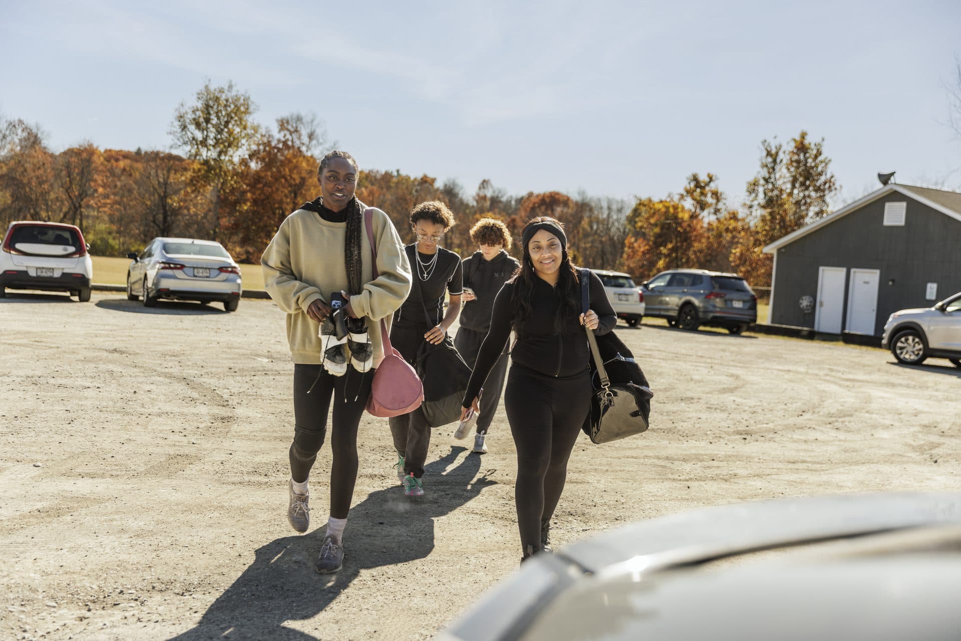 Rural leaders walking together across a gravel lot on an autumn day