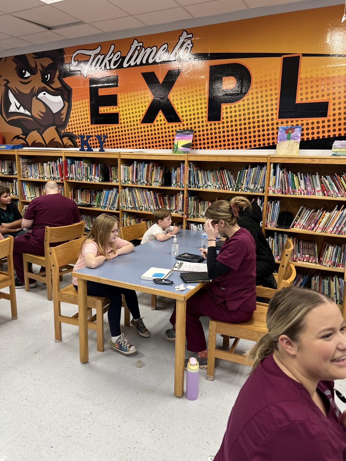 Students seated at a table across from an optometry student